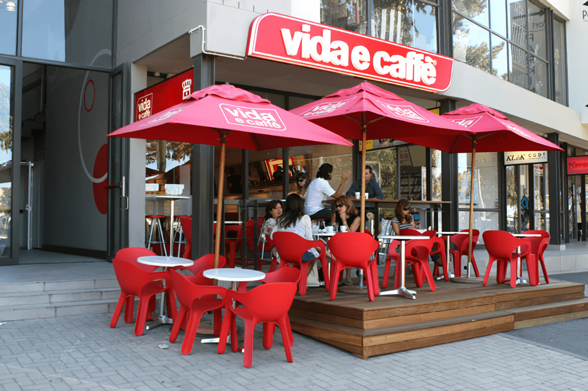 nterior of a vibrant Vida e Caffè café, showcasing stylish décor and customers enjoying coffee. 