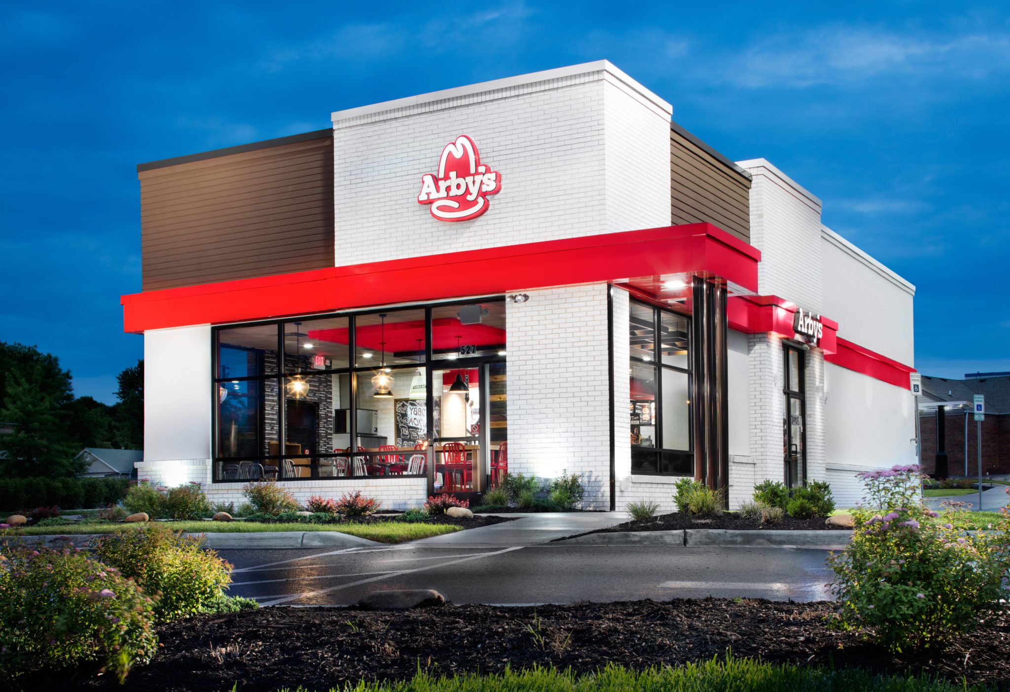 Image: Arby's iconic logo with a delicious sandwich on display.