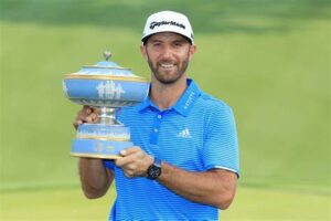 Professional golfer Dustin Johnson, ranked among the highest-paid athletes, smiles on the green, holding his club triumphantly after a successful putt